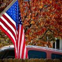 Normal West high school boys hoops raking leaves for Veterans Day