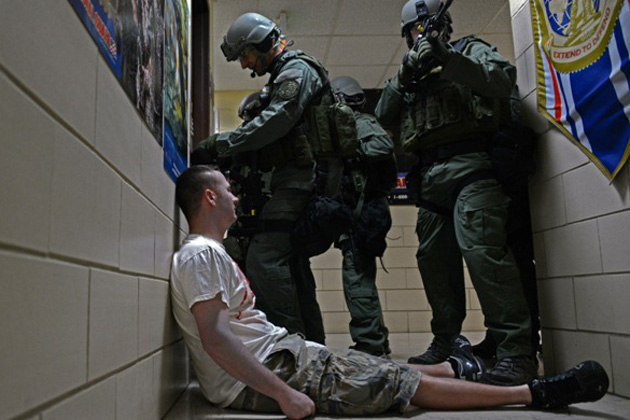 Members of the Springfield, Illinois Police Department SWAT clear a hallway April 23 at the Illinois National Guard base Camp Lincoln in Springfield, Illinois during an active shooter exercise.The emergency exercise included Springfield Police Department, Springfield Fire Department, Sangamon County Sherriff's Department, Sangamon County Office of Emergency Management and other civilian partners. (U.S. Army National Guard photo by Staff Sgt. Robert R. Adams, Illinois National Guard Public Affairs)
