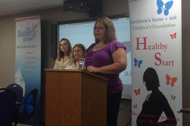 Sarah Bischoff, front, Charlotte Stuckey, two clients of the Crisis Center at Children's Home and Aid, stand with Program Manager Tiffany Powell during a discussion on the state's budget Monday. (Joe Ragusa/WJBC)