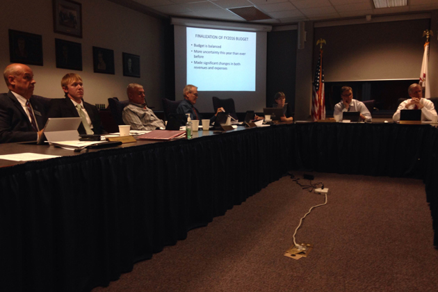 Heartland Community College vice president Doug Minter (far left) presents the fiscal year 2016 budget to the Heartland Community College board Tuesday. (Joe Ragusa/WJBC)
