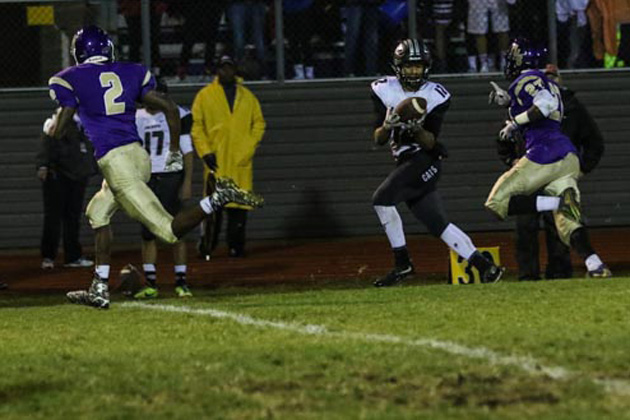 Normal West's Dante Ruffin hauls in a pass between BHS defenders Domeneik Criddell (2) and Carey Ferguson (27). (Photo by Karin McCall/YouNameItSports)